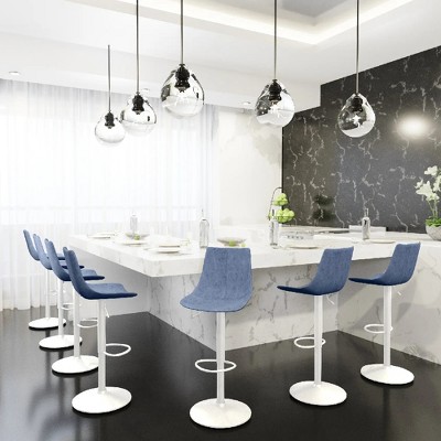 Blue bar stools around a white marble island in a modern kitchen