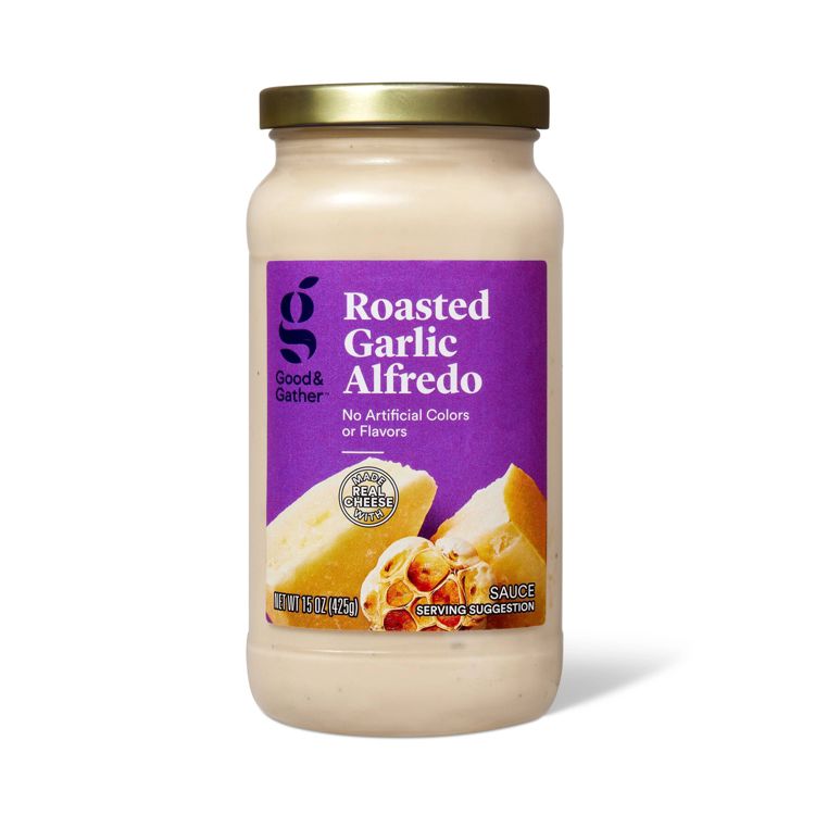 A jar of Good & Gather Roasted Garlic Alfredo sauce with a purple label, showing "No Artificial Colors or Flavors" and "Made with Real Cheese," containing 15 oz (425 g).