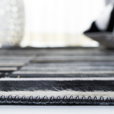 Handmade Black and Beige Geometric Cowhide Area Rug