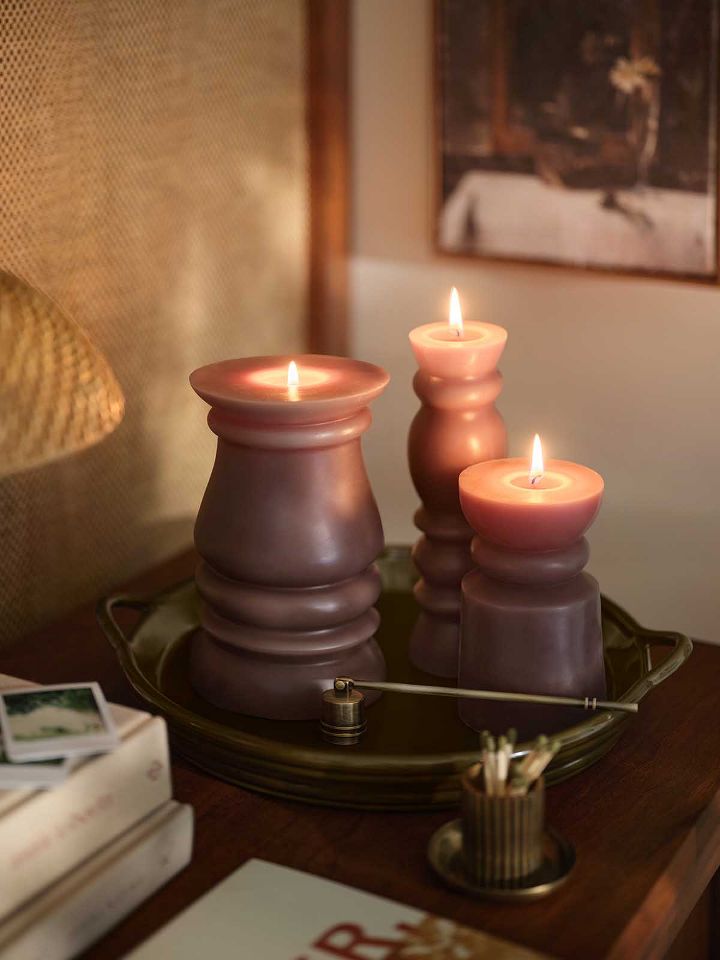 2 pillar candles on gold tray