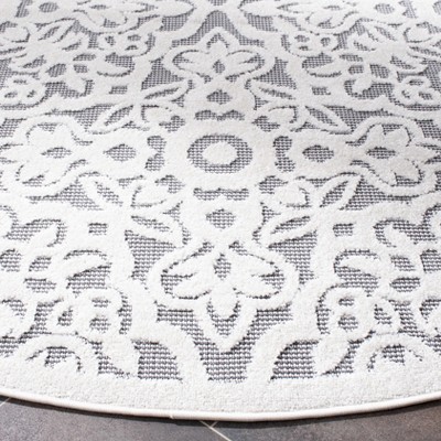 Ivory and Grey Round Geometric Synthetic Indoor/Outdoor Rug