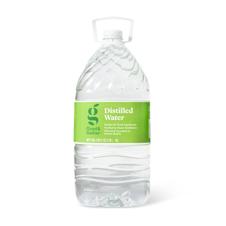 Clear plastic gallon jug of distilled water with a green label showing "Distilled Water" and "128 fl oz (3.78 L)."