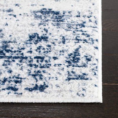 Ivory and Navy Abstract 8' x 10' Synthetic Area Rug