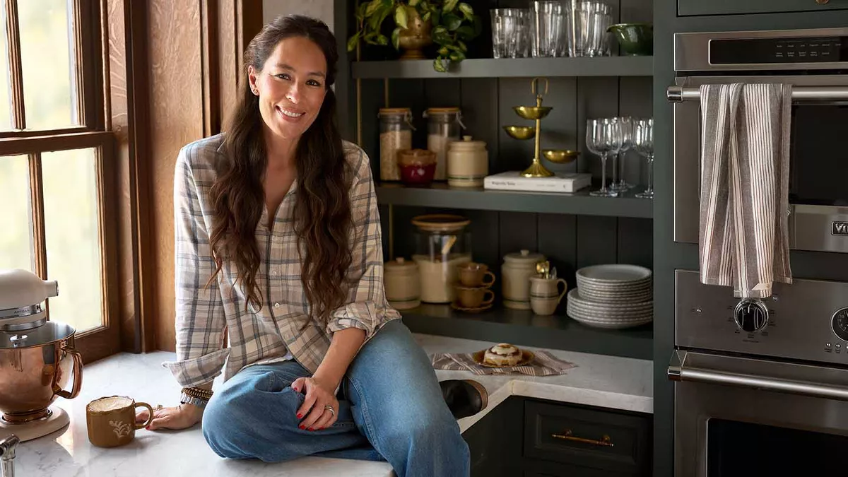 Joanna Gaines sitting on countertop