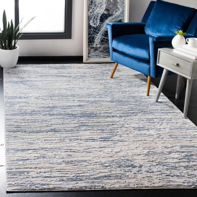 Ivory and Blue Abstract 6&#039; x 9&#039; Stain-Resistant Synthetic Rug