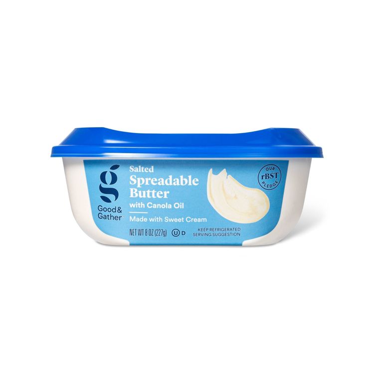 A container of Good & Gather Salted Spreadable Butter with Canola Oil, featuring a blue lid and a label indicating it is made with sweet cream and weighs 8 oz (227 g).