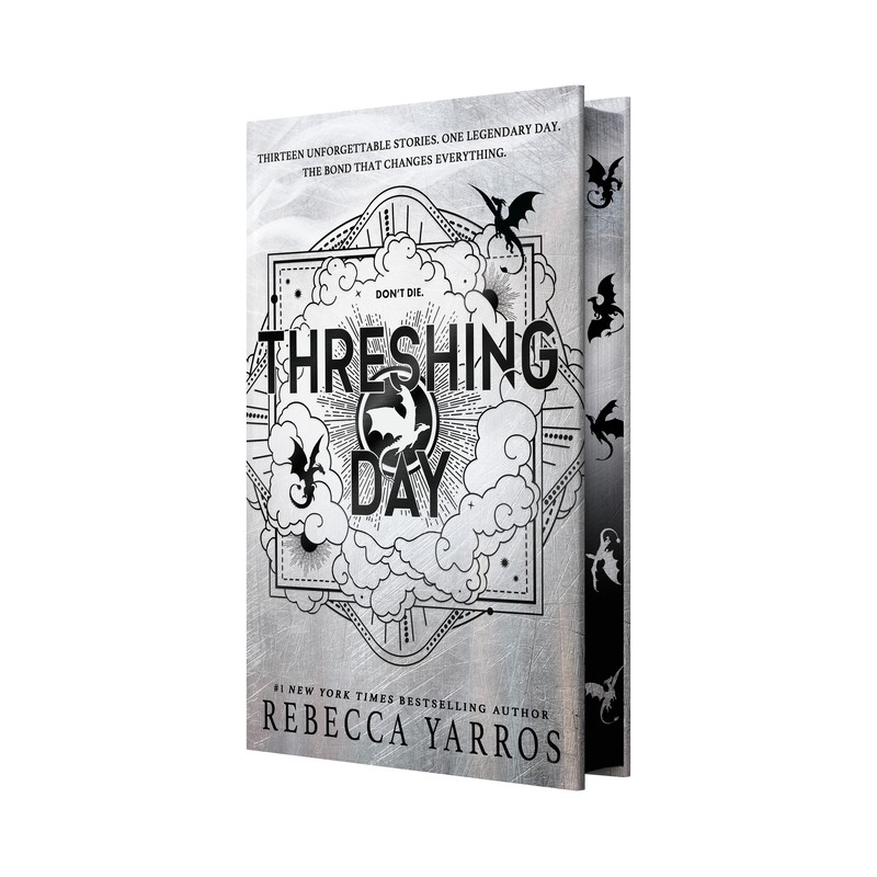 Angled view of the Threshing Day Wing and Claw Collection hardcover showing its black-and-silver dragon-stenciled printed page edges