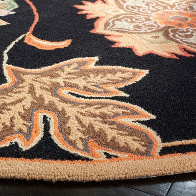 Handmade Black and Orange Floral Wool Area Rug