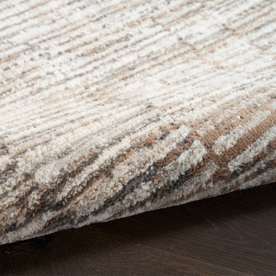 Ivory and Tan Abstract Synthetic Rectangular Rug 5' x 7'