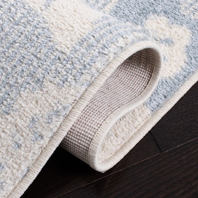 Ivory and Blue Floral Synthetic 6' x 9' Area Rug