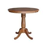 Keanan Round Top Pedestal Table with 12" Drop Leaf Distressed Oak - International Concepts