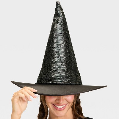A black colored witch hat with a wide brim and a tall, pointed top covered in sequins.