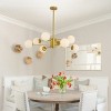 BAOURE 35" Gold Modern Chandelier with White Glass Globe Shades, Elegant Ceiling Light Fixture for Dining Room, Living Room, or Bedroom - 3 of 4