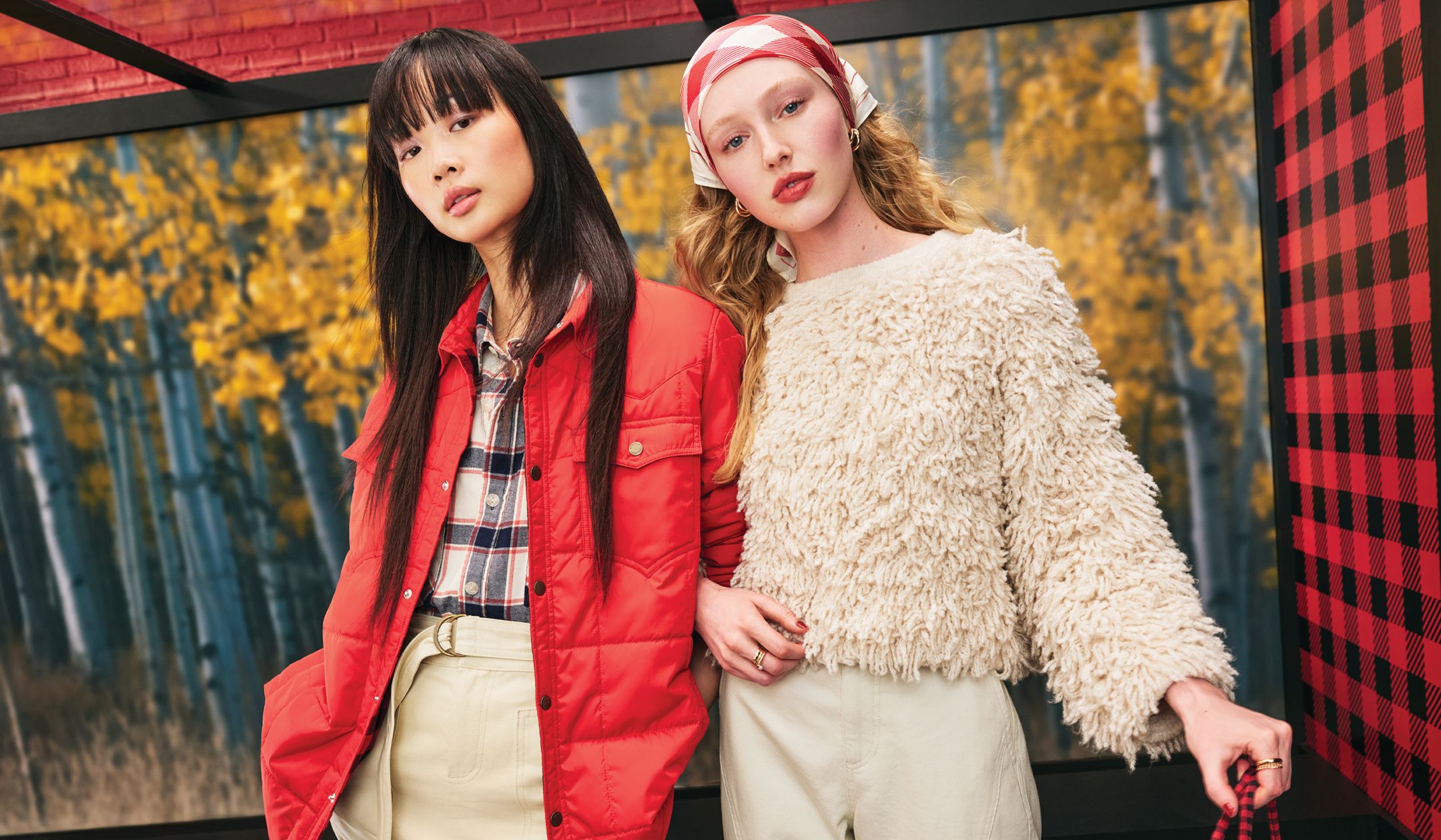 woman in an oversize black & white plaid shirt with red quilted jacket and cream wrap skirt; and a woman in a cream, loopy yarn sweater with a silky red & cream buffalo check bandana and cream barrel cargo pants.