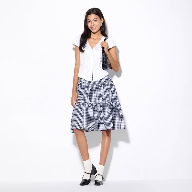 A black and white checkered knee-length skirt with a tiered design.