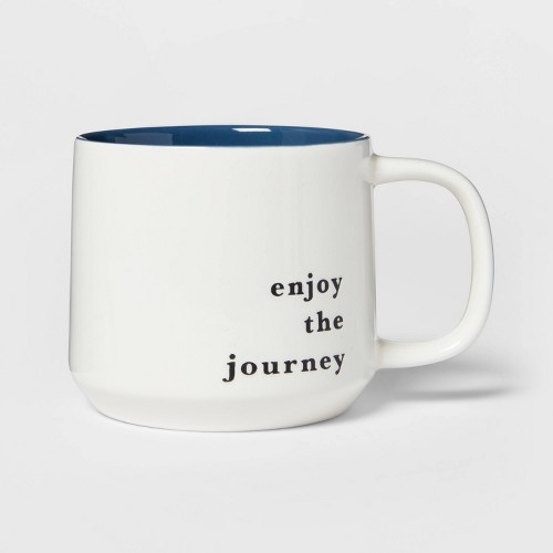 white stoneware mug with blue interior that says 'enjoy the journey' on the exterior