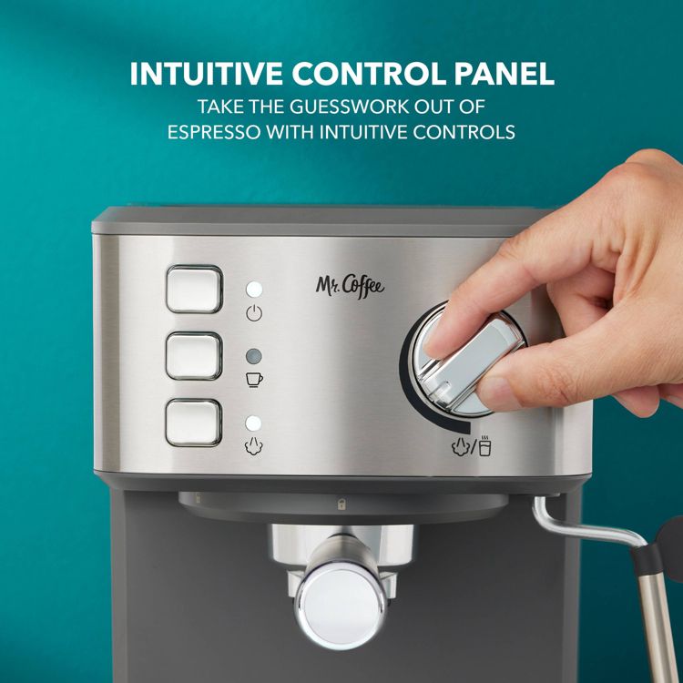 A hand adjusts the dial on a stainless steel espresso maker with labeled buttons and the text "INTUITIVE CONTROL PANEL" above.