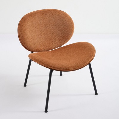 Another angle of orange-brown shell chair with black legs