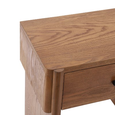 Wooden nightstand with a visible drawer and smooth, rounded edges.