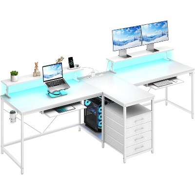 This 94.5-inch T-shaped gaming desk for two features a power outlet, LED lights, and includes a monitor stand with storage shelves and a keyboard tray