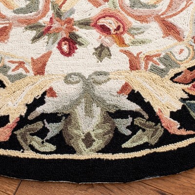Handmade Ivory and Black Floral Wool Round Rug