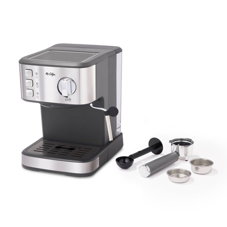 A silver and black colored espresso maker with a steam wand, accompanied by a portafilter, tamper, and two filter baskets.