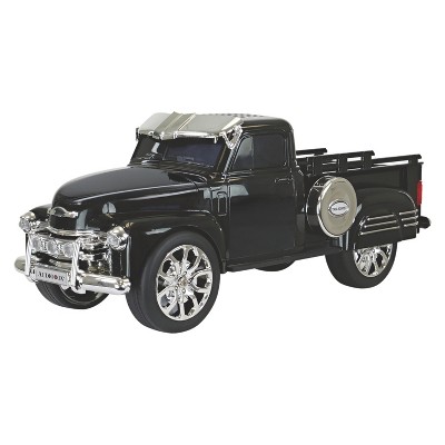 Small Toy Truck Carries A Large Black Subwoofer Or Audio Speaker