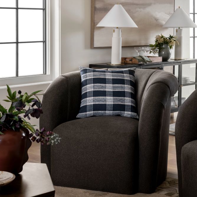 Blue plaid throw pillow on brown accent chair