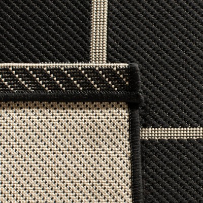 Black and Creme Rectangular 8' x 10' Synthetic Area Rug