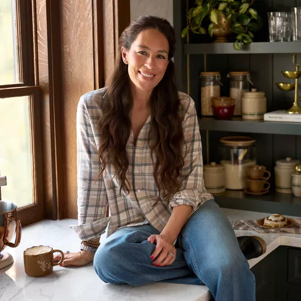 Joanna Gaines sitting on countertop