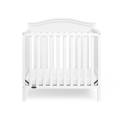 Stella White Pine Wood 4-in-1 Convertible Mini Crib with Foam Mattress