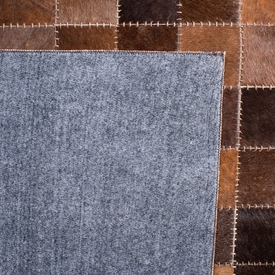Handmade Brown and Beige Geometric Cowhide Area Rug