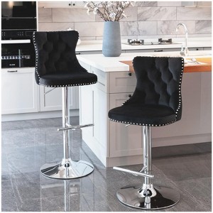 The two modern gray velvet swivel bar stools are height, backrest, and footrest adjustable. - 1 of 4