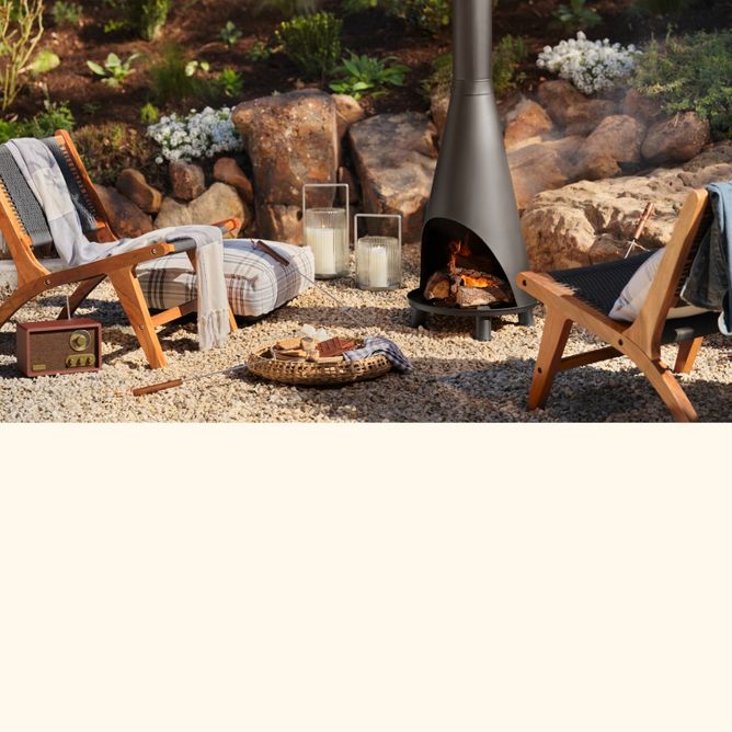 Outdoor area with lit chiminea, lounge chairs and s'mores tray