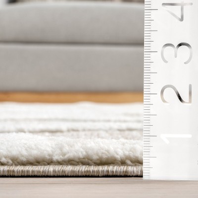 Ivory and Beige Abstract High-Low Tasseled 6'7" x 9' Area Rug
