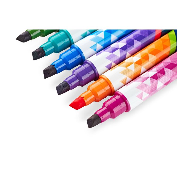 Seven colored markers with geometric patterns on the barrels, featuring tips in green, teal, blue, purple, red, orange, and pink.