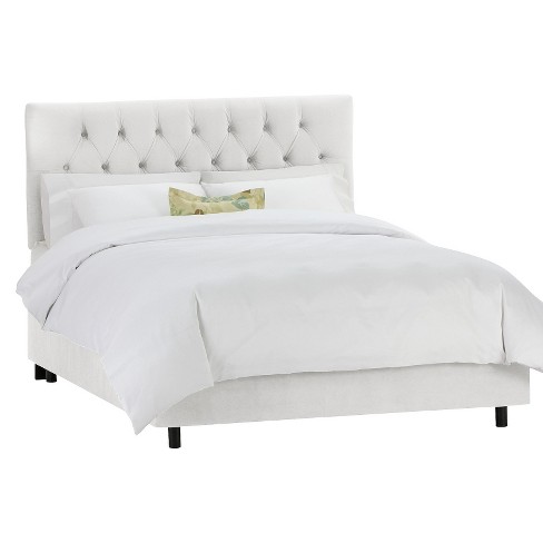 White upholstered store bed queen