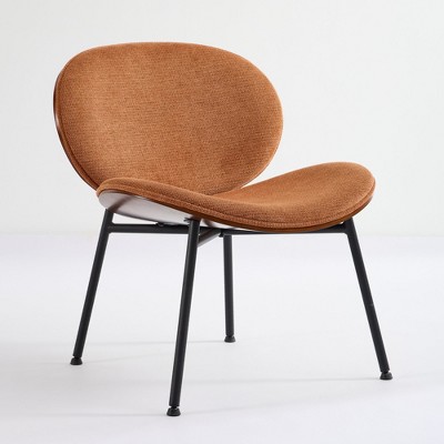 Three-quarter view of orange-brown shell chair with black legs