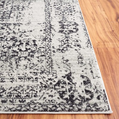 Ivory and Black Reversible Easy-Care Synthetic Area Rug - 6'7" x 9'