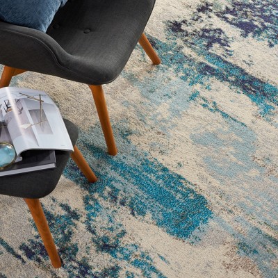 Ivory and Teal Blue Abstract 6' x 9' Synthetic Area Rug