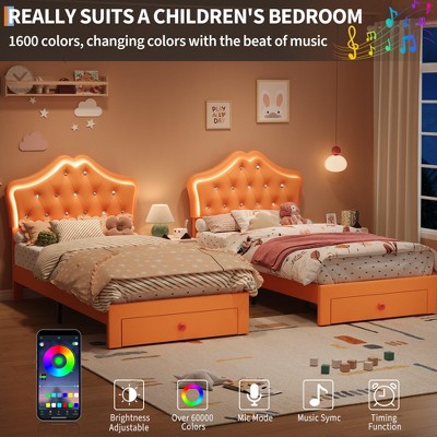 Two orange tufted twin beds with storage drawers in a shared children's room
