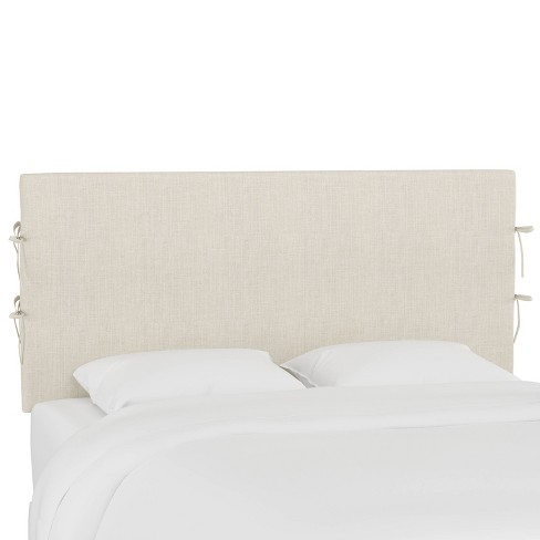 white linen slipcovered bed