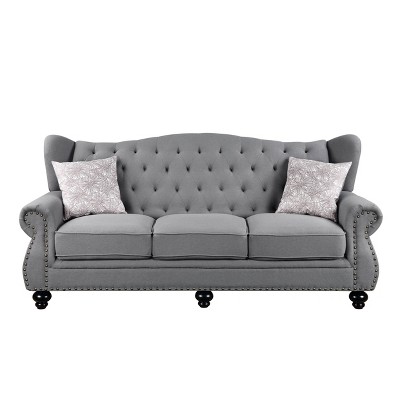 Gray Fabric Camelback Sofa with Floral Cushions and Nailhead Trim