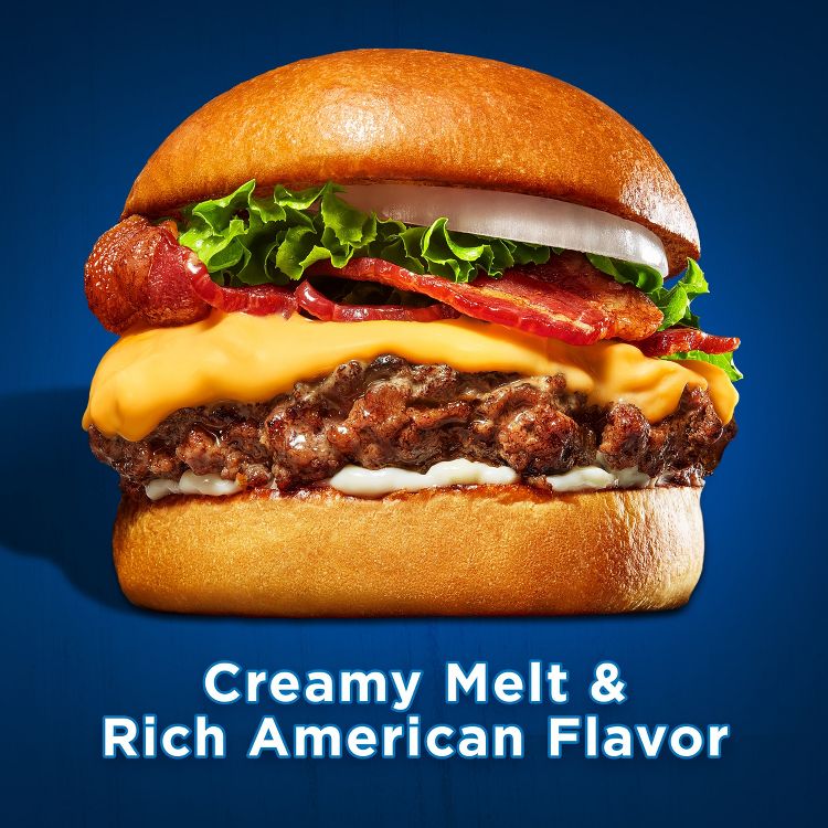 A hamburger with melted cheese, bacon, lettuce, and onion on a bun, with the text "Creamy Melt & Rich American Flavor" below.