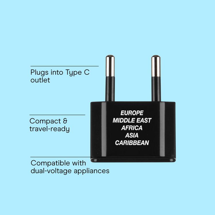 Black colored adapter with two metal prongs, labeled for use in Europe, Middle East, Africa, Asia, and Caribbean, with text indicating compatibility with Type C outlets and dual-voltage appliances.