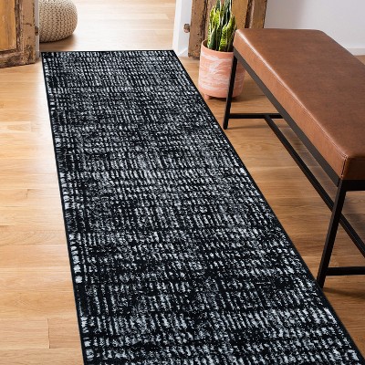 Black and Ivory Geometric Polypropylene Area Rug 2' x 7'