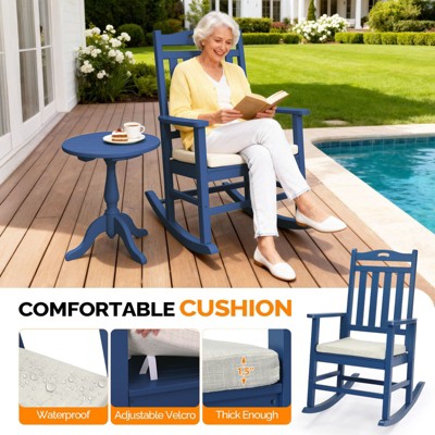 Blue wooden rocking chair with off-white cushion on a patio