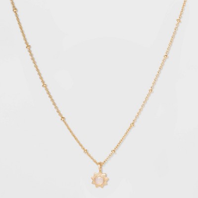 short gold necklace with charm