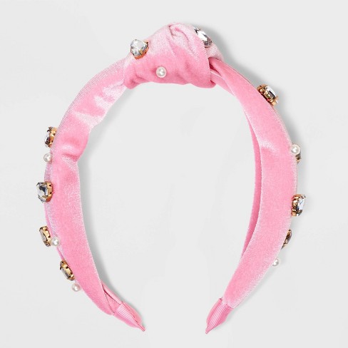 Crystal and pearl trim on a pink elastic headband