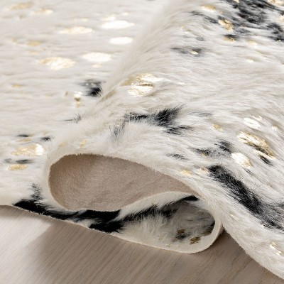 Black and White Tufted Synthetic Cowhide Accent Rug